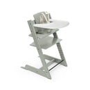 Stokke Tripp Trapp high chair in Glacier Green with a cushion and tray, featuring a secure harness and adjustable footrest.