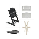 Stokke Tripp Trapp® High Chair in black, with grey cushion, tray, and safety harness displayed separately.
