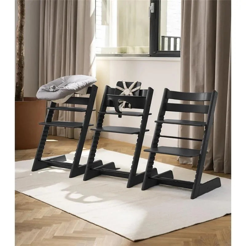 Stokke Tripp Trapp high chair set in Glacier Green, featuring a cushion and tray, arranged in a modern interior setting.
