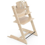 Stokke Tripp Trapp® High Chair in natural wood finish, featuring adjustable seating positions and safety harness.