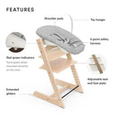 Stokke Tripp Trapp Newborn set in natural finish, features adjustable seat, safety harness, shoulder pads, and toy hanger.