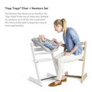 Stokke Tripp Trapp® Chair with Newborn Set, featuring a mother interacting with her baby seated in a cozy infant support.