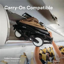 Yoyo stroller in taupe being placed in an airplane overhead compartment, showcasing its carry-on compatibility and folded dimensions.