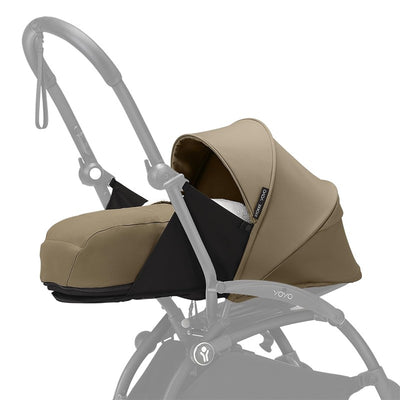 Stokke Yoyo 0+ Newborn Pack in Toffee, featuring a soft brown fabric, a fitted hood, and a sturdy carrying frame.