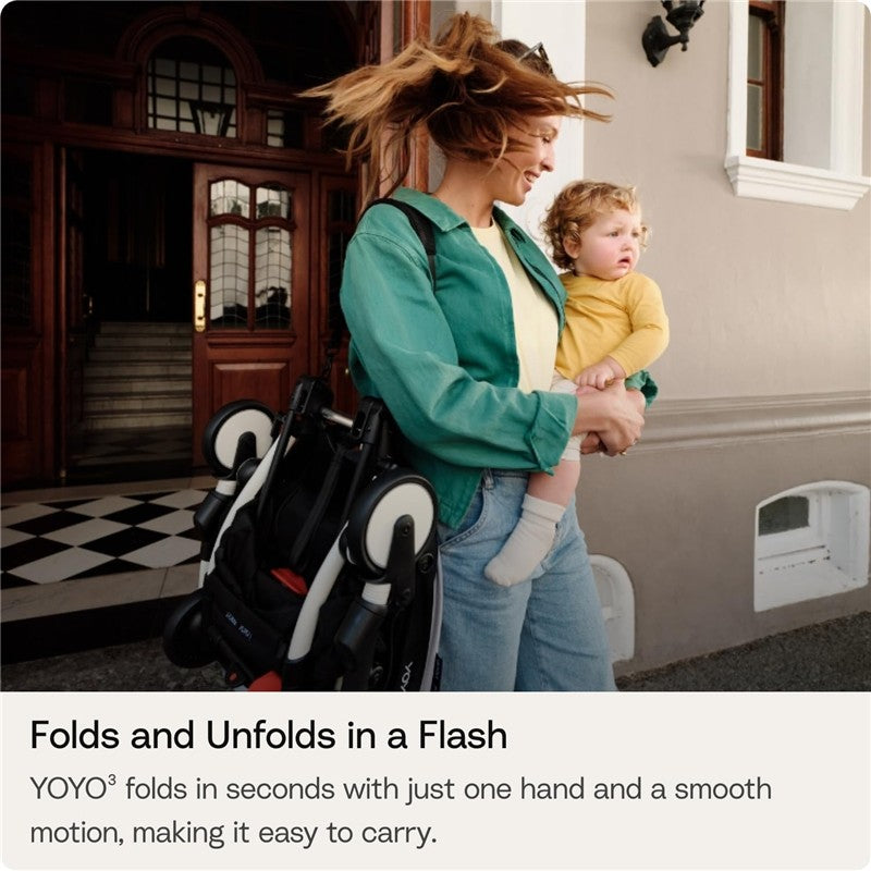 Stokke Yoyo 0+ Newborn Pack in Toffee, held by a woman carrying a child, showcasing easy portability and design.