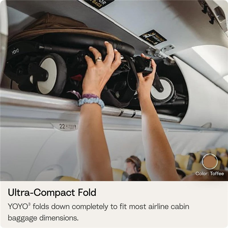 Hands placing the Stokke Yoyo 0+ Newborn Pack in an airplane overhead compartment, emphasizing its ultra-compact fold.