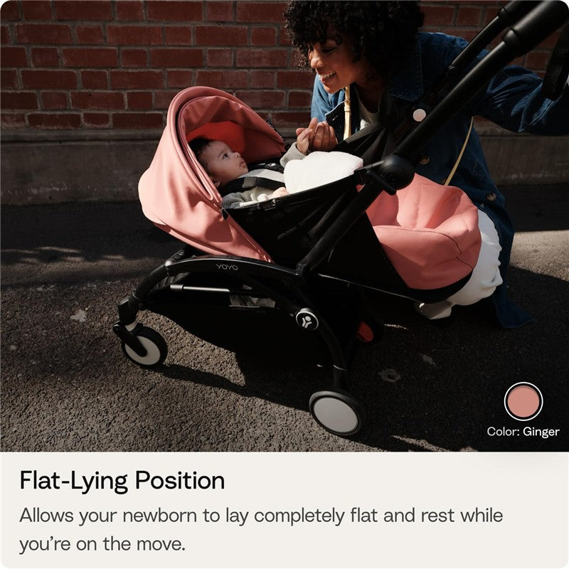 Stokke Yoyo 0+ Newborn Pack in Toffee, featuring a woman interacting with a baby in the stroller, emphasizing flat-lying position.