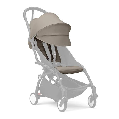 Taupe color pack for the Stokke Yoyo 6+ stroller, featuring a sun canopy, padded seat, and adjustable straps.