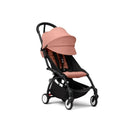 Stokke Yoyo³ stroller in black frame with ginger fabric, featuring a large canopy, padded seat, and under-seat storage.
