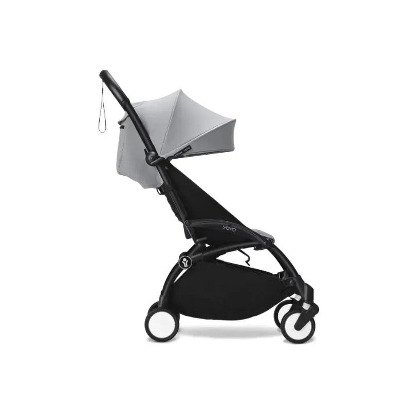 Stokke Yoyo³ stroller with a black frame and stone fabric, featuring a reversible seat, adjustable canopy, and leg rest.