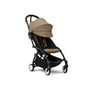 Stokke Yoyo³ Stroller 6+, featuring a black frame with a toffee-colored seat and canopy, designed for children 6 months and older.