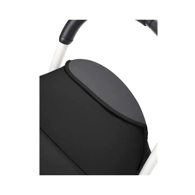 Detail of the Stokke Yoyo³ 6+ stroller featuring a black fabric seat and a white frame.