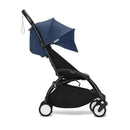 Stokke Yoyo³ stroller in black with blue canopy, designed for children 6+, showcasing a sleek, compact design.
