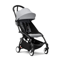 Stokke Yoyo³ stroller in black and stone, featuring a lightweight design, adjustable canopy, and safety harness.