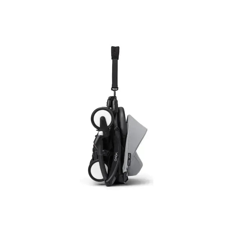 Stokke Yoyo³ stroller in black and stone color, compactly folded for easy transport.