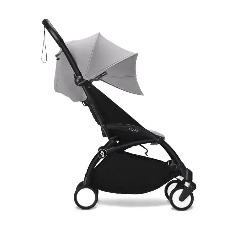 Stokke Yoyo³ stroller in black with a stone canopy, designed for children 6 months and up, featuring a compact frame.