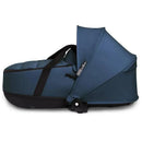 Navy bassinet from the Stokke Yoyo³ stroller bundle, featuring a black frame and a foldable canopy.
