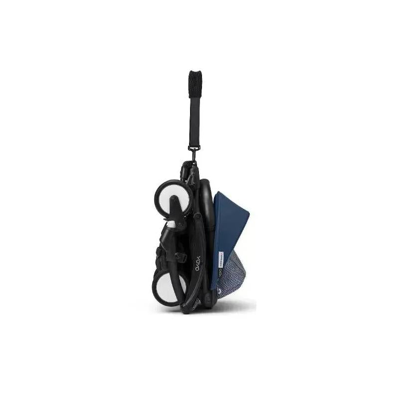 Stokke Yoyo³ stroller bundle in a compact folded position, featuring a black frame and navy color pack.