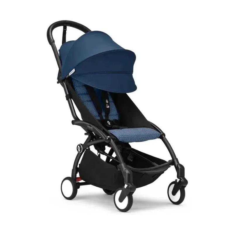Stokke Yoyo³ stroller in black frame with navy color pack, featuring a compact design and a large sun canopy.