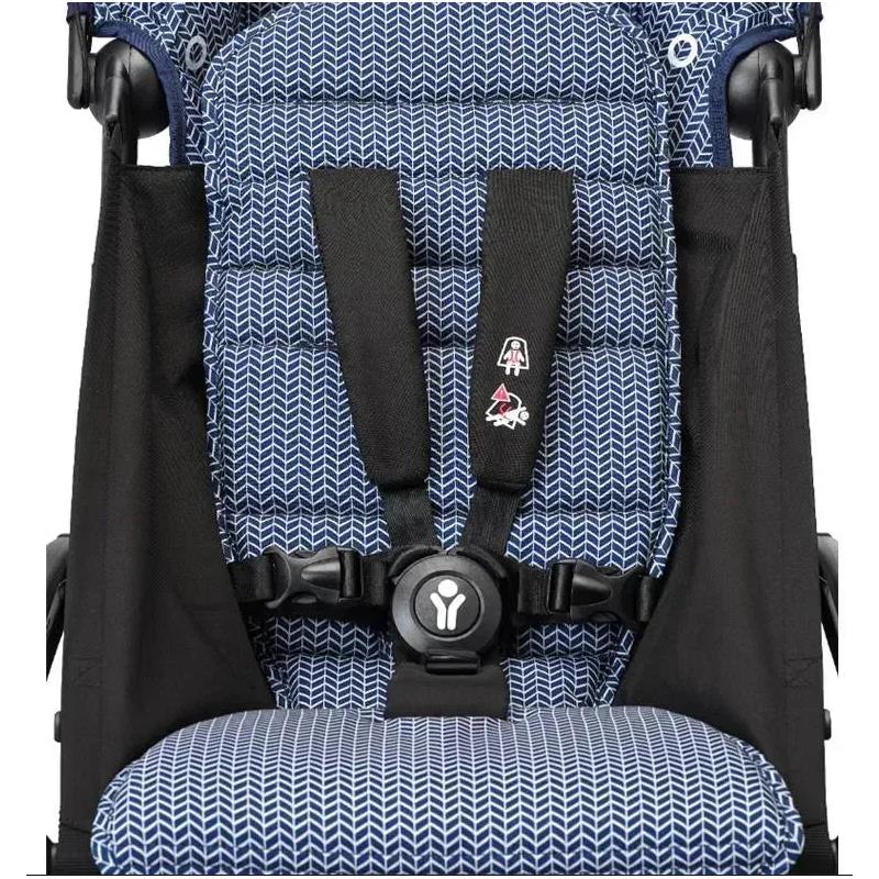 Navy patterned seat fabric with harness system for the Stokke Yoyo³ stroller, featuring a black frame and secure buckle.