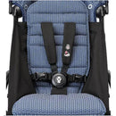 Navy patterned seat fabric with harness system for the Stokke Yoyo³ stroller, featuring a black frame and secure buckle.