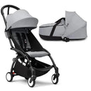 Stokke Yoyo³ stroller with black frame and a stone bassinet, featuring a gray canopy and seating fabrics.