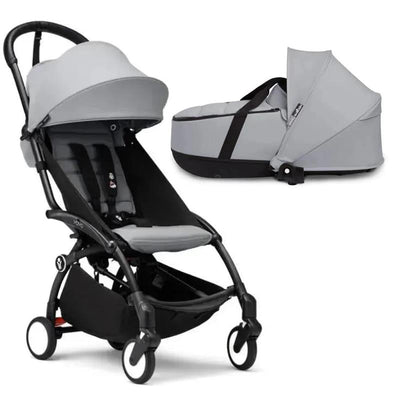 Stokke Yoyo³ stroller with black frame and a stone bassinet, featuring a gray canopy and seating fabrics.