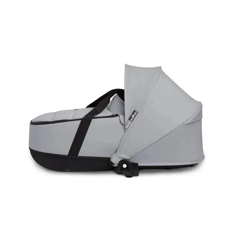 Stokke Yoyo³ stroller bassinet in stone color, featuring a sleek design with a black base and adjustable canopy.