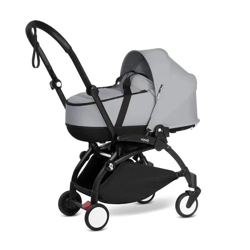Stokke Yoyo³ Stroller Bundle with black frame, featuring a stone color pack and stone bassinet attachment.