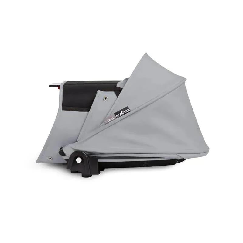 Stokke Yoyo³ stroller bundle featuring a black frame and a stone color pack, with a folded stone bassinet.