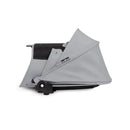 Stokke Yoyo³ stroller bundle featuring a black frame and a stone color pack, with a folded stone bassinet.
