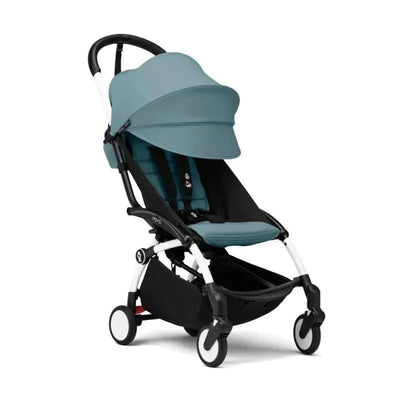 Stokke Yoyo³ stroller with a white frame, featuring aqua fabric, designed for children 6 months and older.