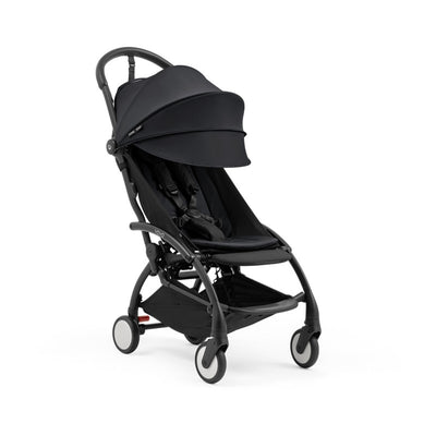 Compact Yoyo5 stroller with a black frame and fabric, featuring a large canopy and safety harness, designed for easy transport.