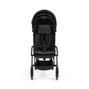 Compact black stroller with a black frame, featuring a padded seat, safety harness, and a storage basket underneath.