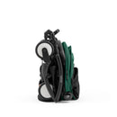Compact Stokke Yoyo5 stroller with a black frame, folded with a forest green seat fabric and visible wheels.