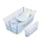 Stokke® Flexi Bath® Bundle in Ocean Blue, featuring a transparent bathtub with water and bubbles, plus a foldable bath support.