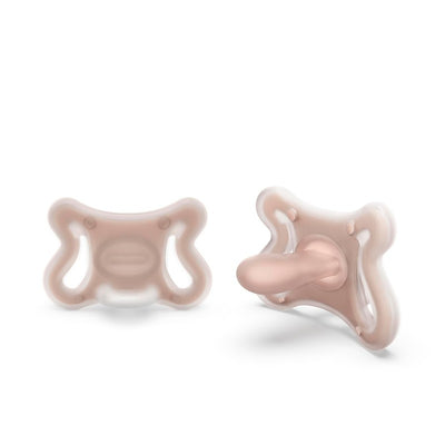 Two Suavinex silicone baby pacifiers in soft pink, featuring an SX Pro physiological nipple, designed for medium-sized babies.