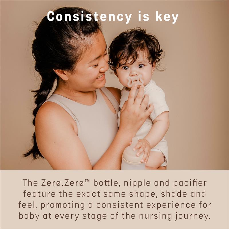Mother holding a baby with a pacifier, showcasing the Suavinex Zero Zero Newborn Starter Set, emphasizing consistency in design.