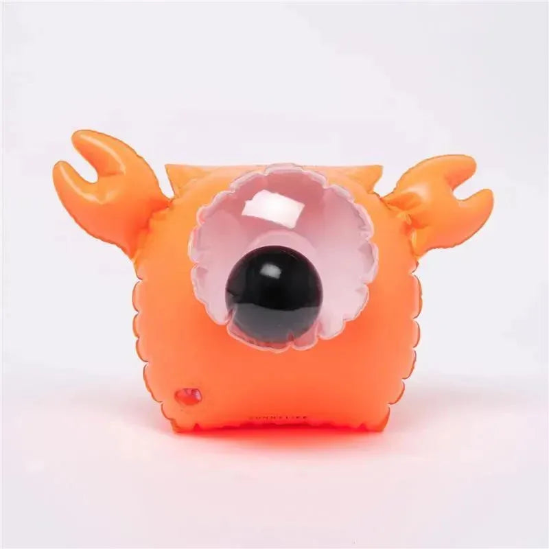 Buddy Float Bands in the shape of Sonny the Sea Creature, featuring an orange design with large black eye and claw-like appendages.