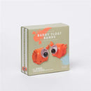 Orange inflatable float bands shaped like Sonny the Sea Creature, packaged with a warning label and colorful background.