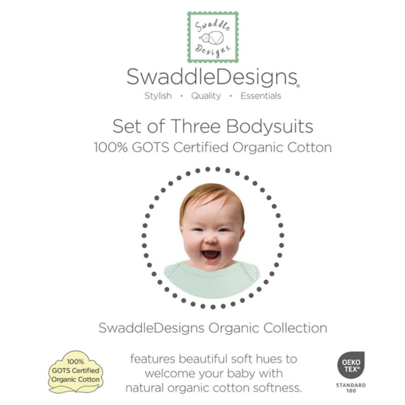 Set of three organic cotton bodysuits in soft jadeite, white, and sand dollar with baby model smiling.