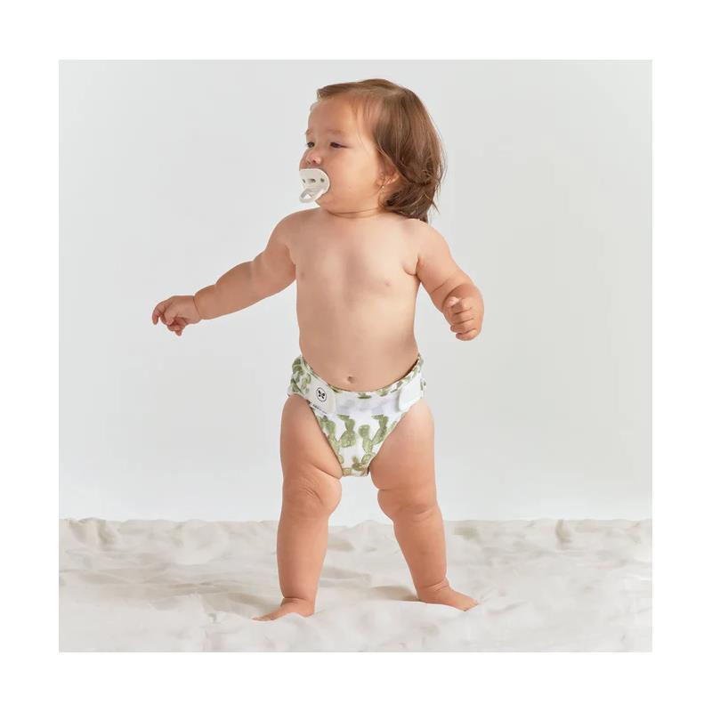 Child wearing a Swaddle Designs Honest Cotton Muslin Hybrid Reusable Cloth Diaper Cover in a cactus print.