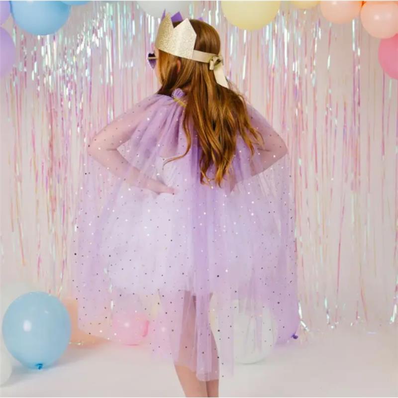 Child wearing a lavender dress up kit with a sparkling cape and crown, surrounded by pastel balloons and a festive backdrop.