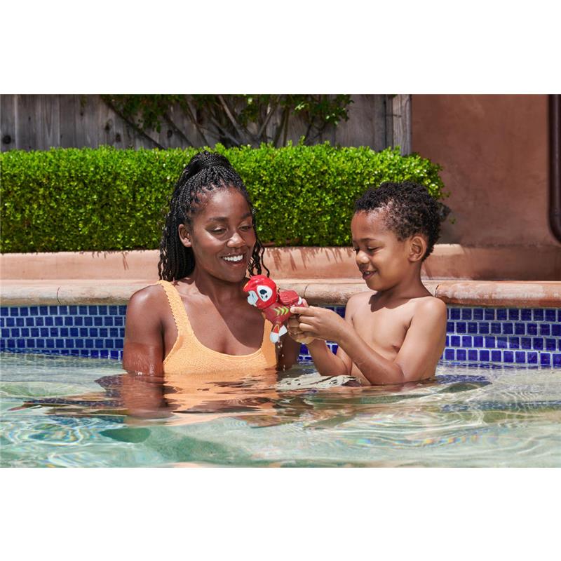 A woman and child in a pool joyfully engage with a Paw Patrol floating figure, enhancing their playtime experience.