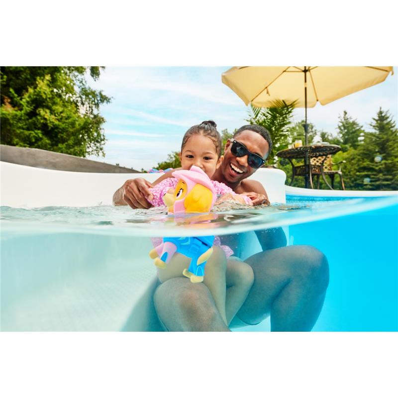 Child and adult enjoying a pool with a Paw Patrol floating figure, both smiling and playing in the water.