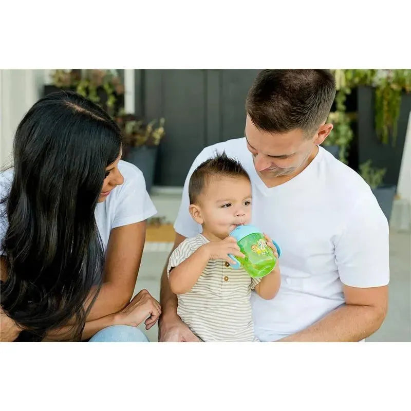 Cocomelon Kids Weighted Trainer Cup held by a toddler, with two adults observing and smiling in a home setting.
