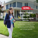Girl holding a Thermos FUNtainer 12 oz stainless steel water bottle in turquoise, standing in front of a home, smiling.