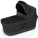 Black Thule Bassinet with a sunshade, featuring a sleek design and zippers for easy access and functionality.