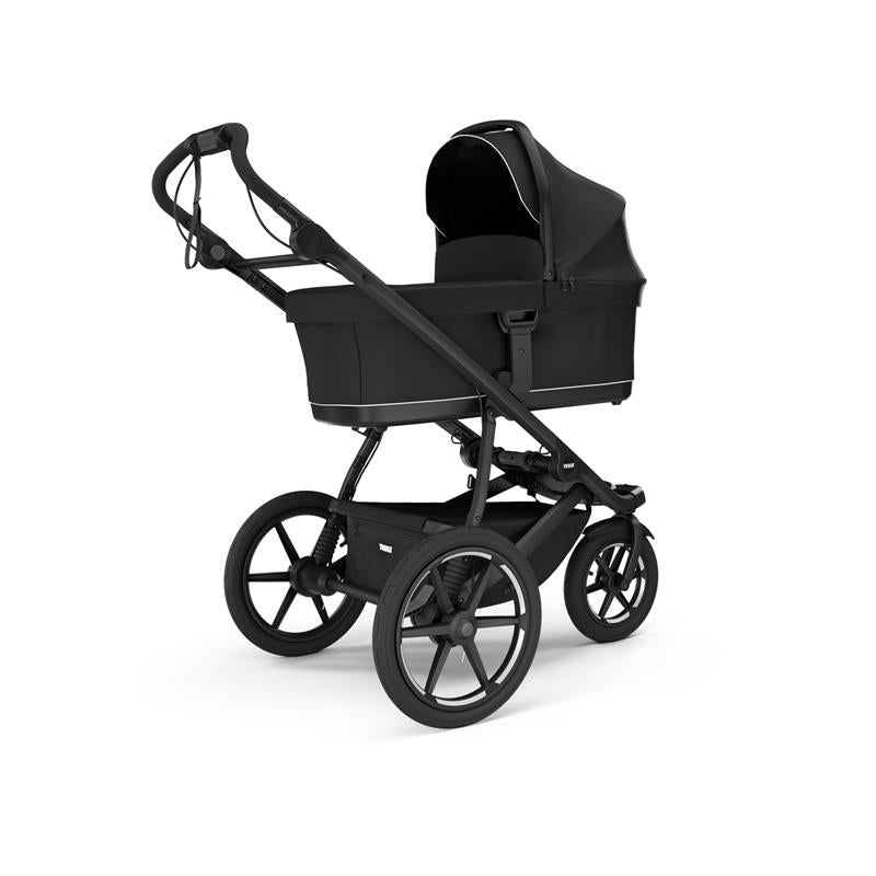 Thule Bassinet in black, designed for infants, features a sturdy frame and a protective canopy.