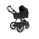 Thule Bassinet in black, designed for infants, features a sturdy frame and a protective canopy.